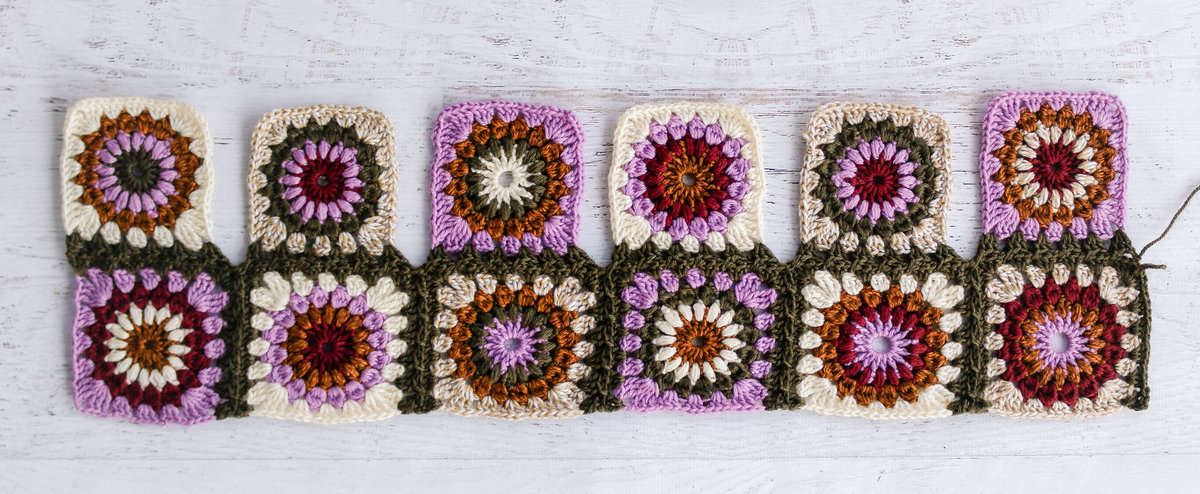 Vibrant crochet granny squares being joined as you go.