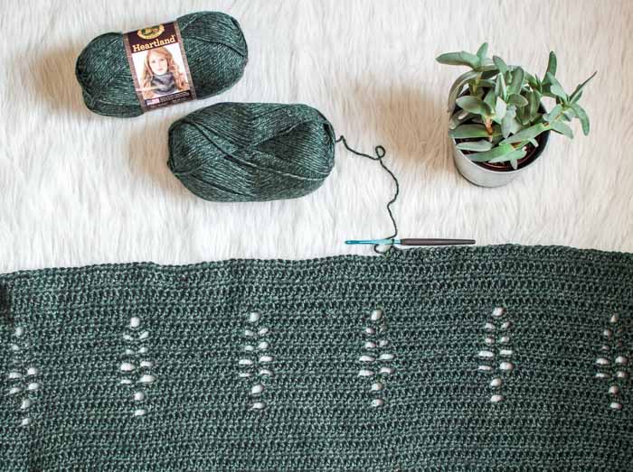 Free crochet pattern for a long sleeveless kimono with tree cutout pattern, using Lion Brand Heartland yarn.