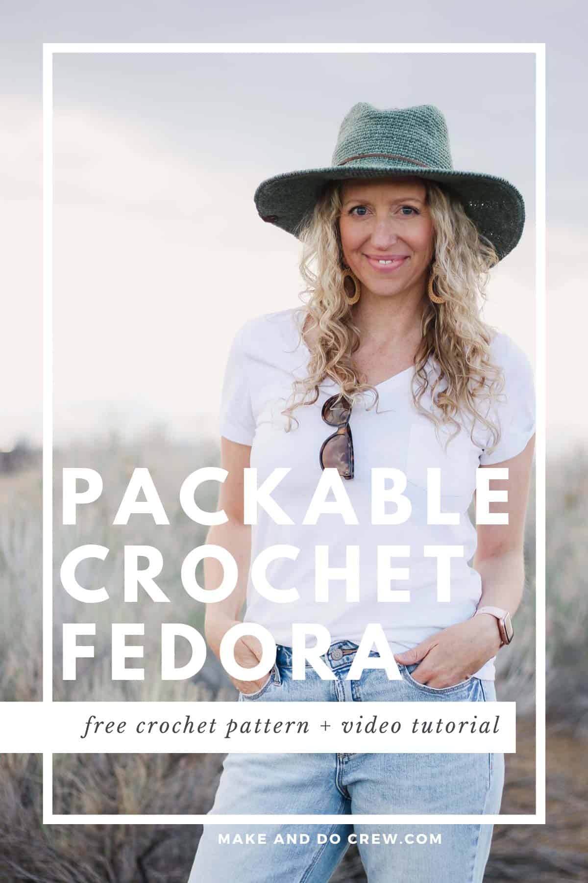 Woman standing in a field wearing a fedora crochet sun hat made with raffia-like yarn.