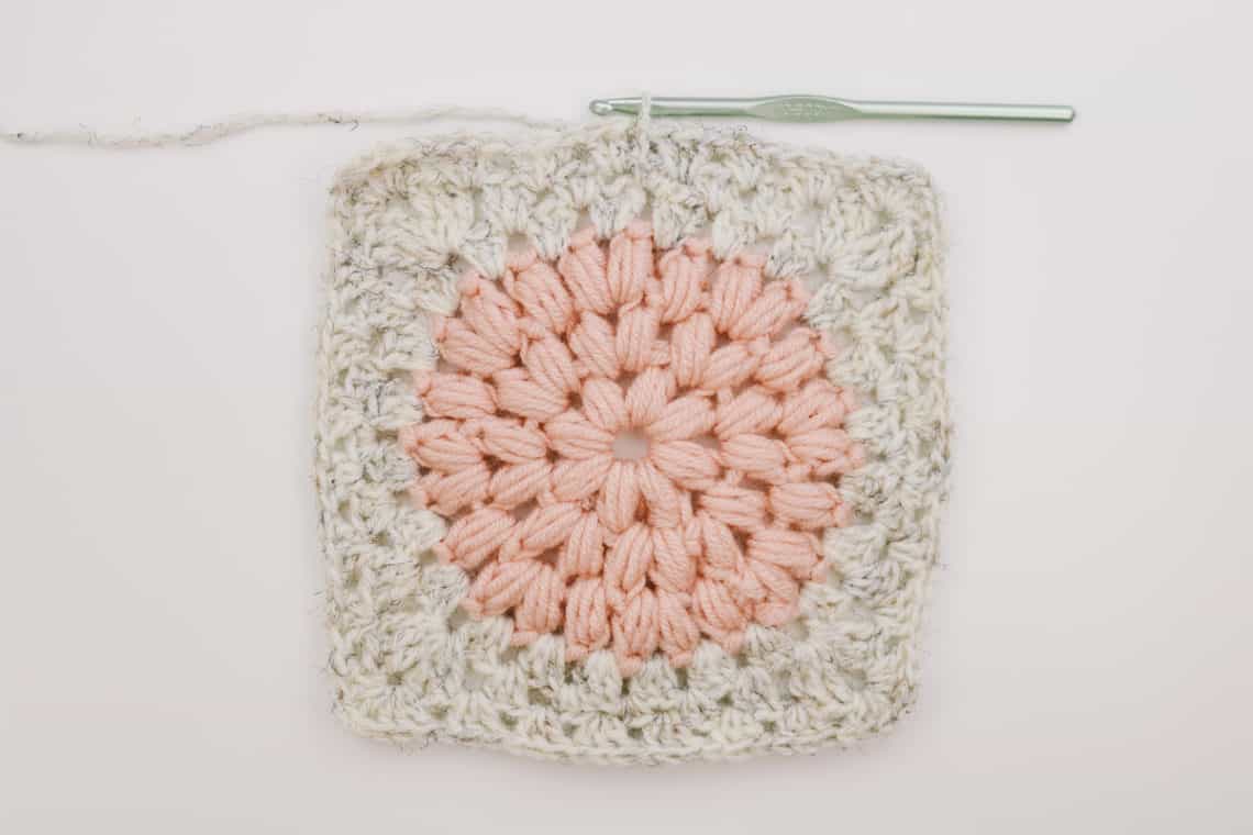 Unique crochet granny square made from puff stitches and regular granny stitches.