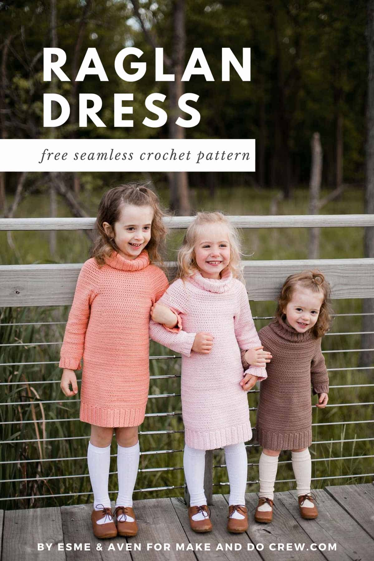 Three girls standing on sidewalk wearing crochet sweater dresses in coral, light pink, and brown. The girls are hooking their arms together and smiling.