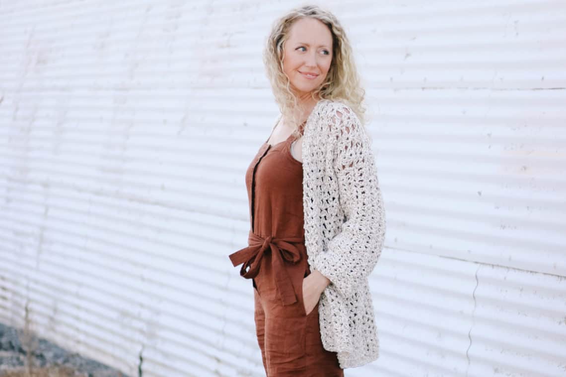 Blonde woman wearing a casual crochet jacket made with the iris stitch and Lion Brand Twisted Cotton Blend yarn.