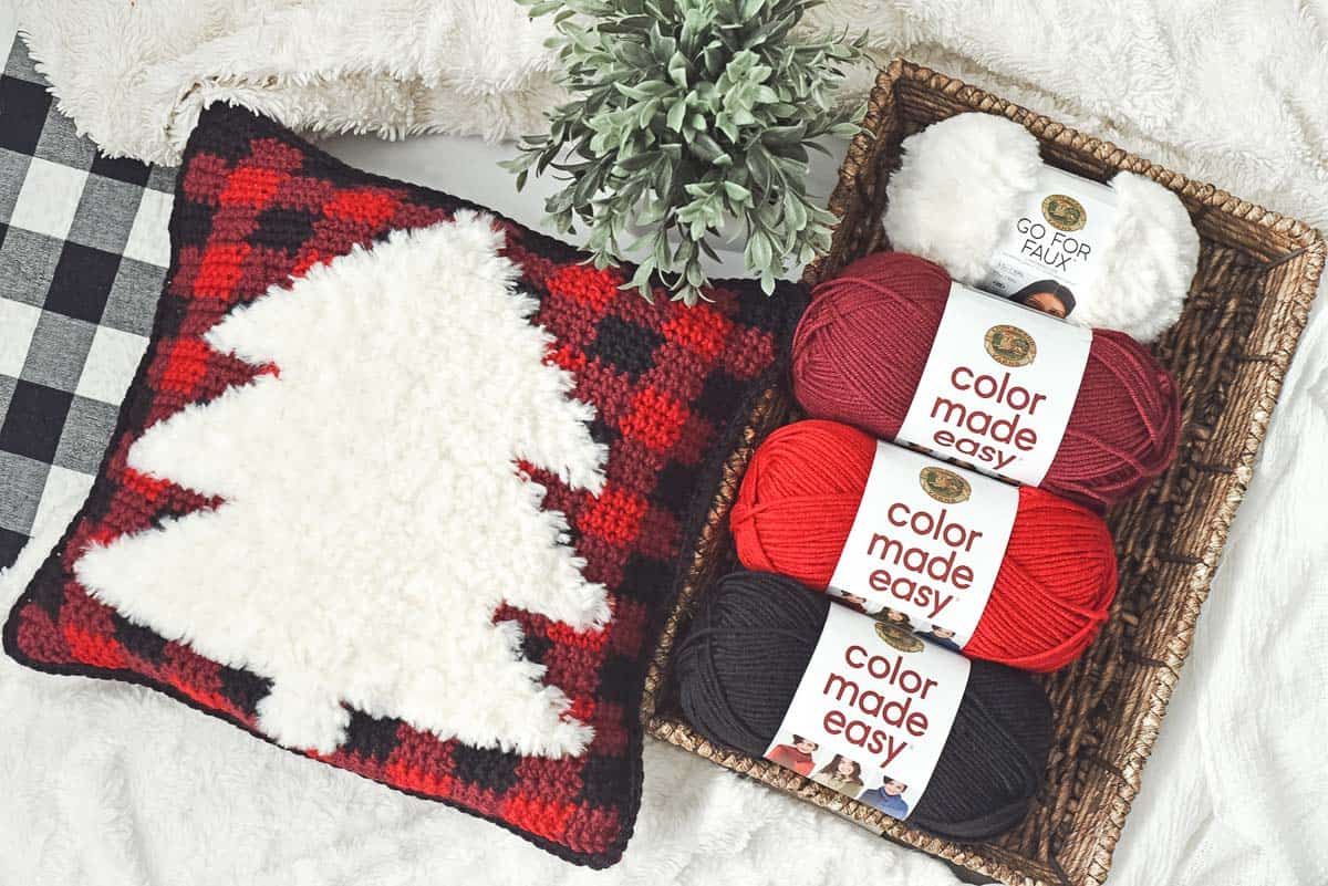 Buffalo plaid crochet Christmas pillow pattern with a faux fur tree. (Color Made Easy + Go For Faux yarn.)