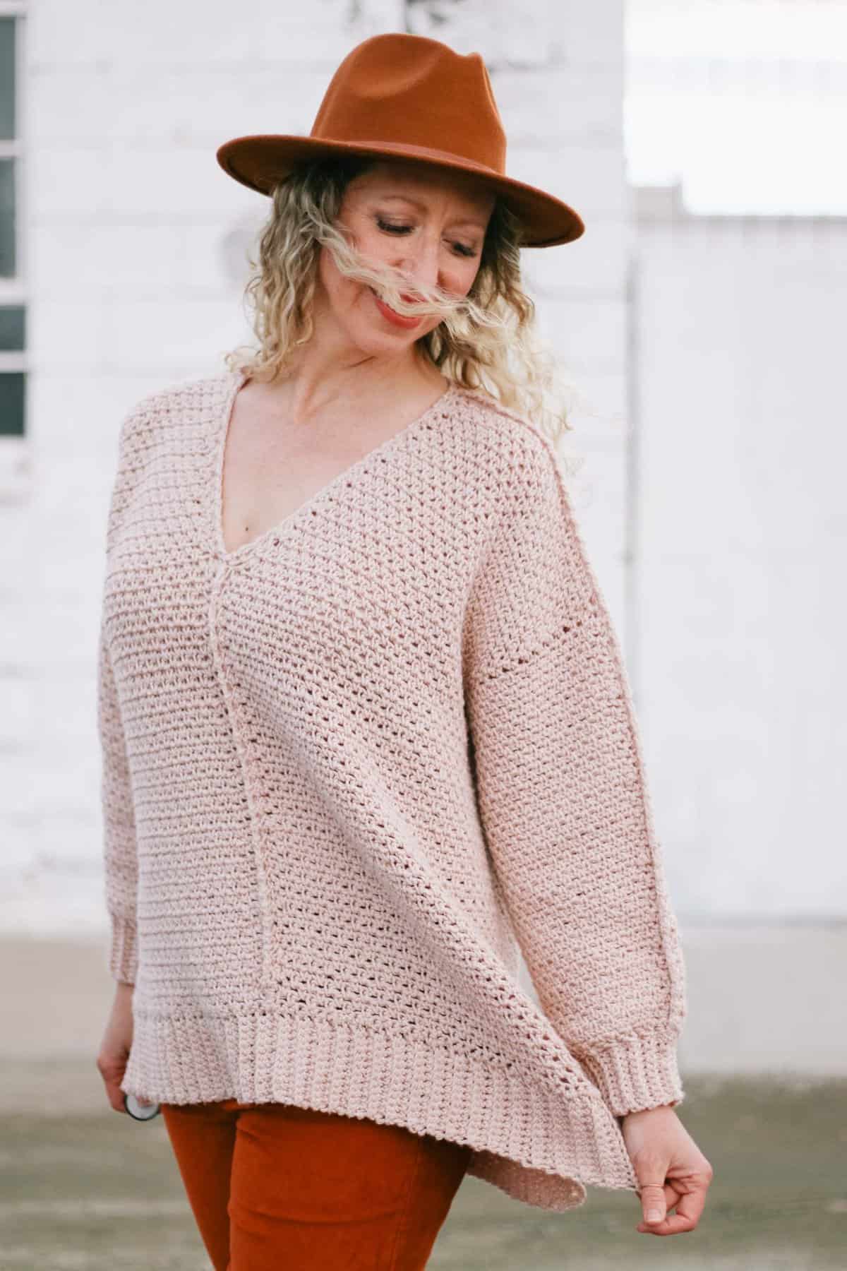 Woman wearing casual crochet pullover pattern with stylish exposed seams.