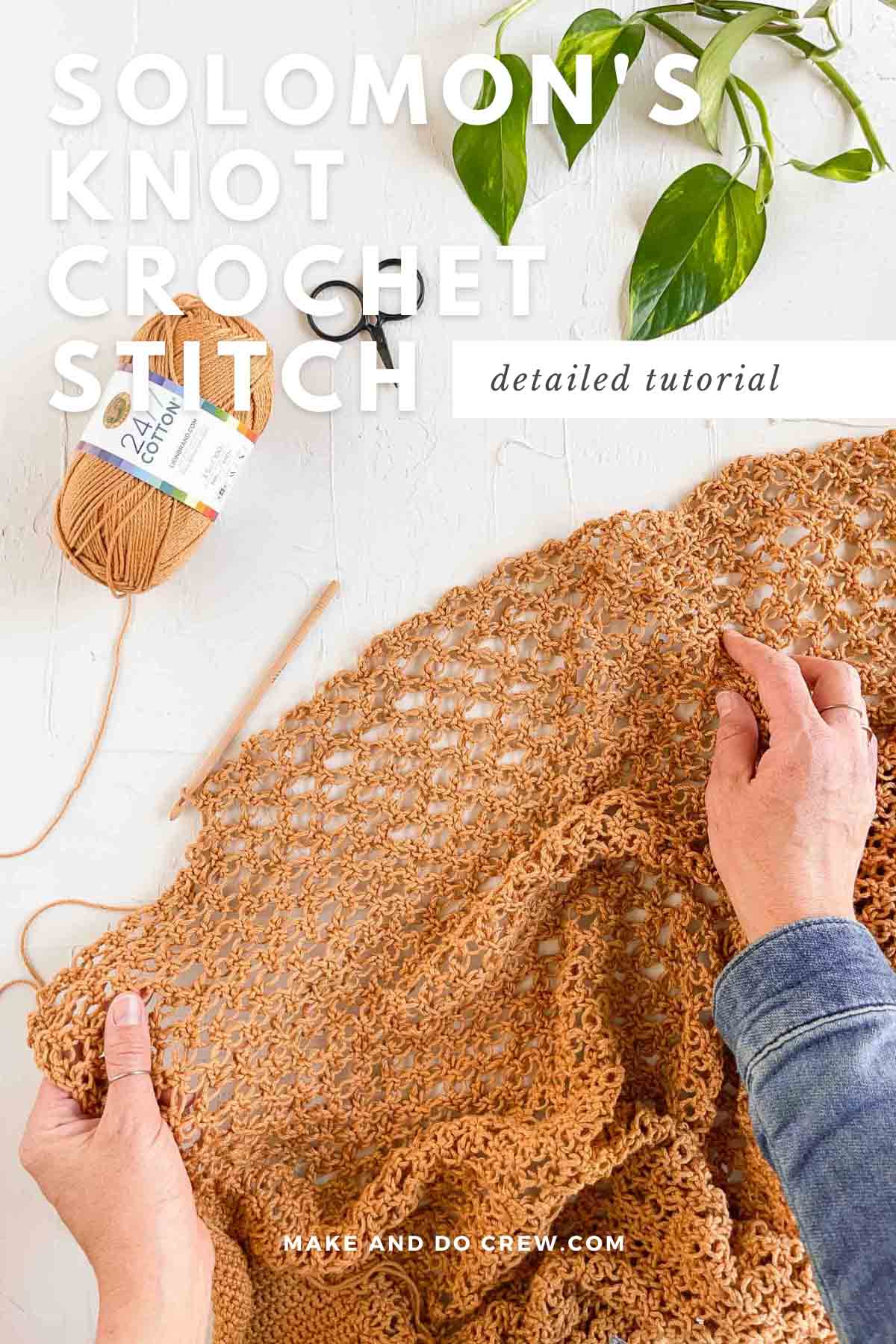 A woman's hand holding an in-progress crochet pattern using Solomon's knot stitch.
