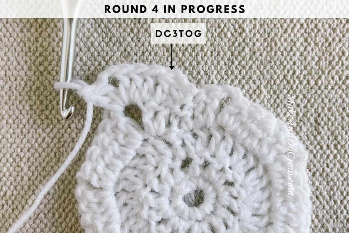 Crochet photo tutorial image showing round four of crocheting a star in progress.