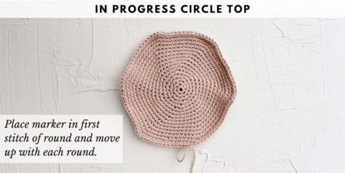 This image shows a crochet tutorial for how to make a bucket hat out of granny squares. The photo shows the in progress circle top of hat.