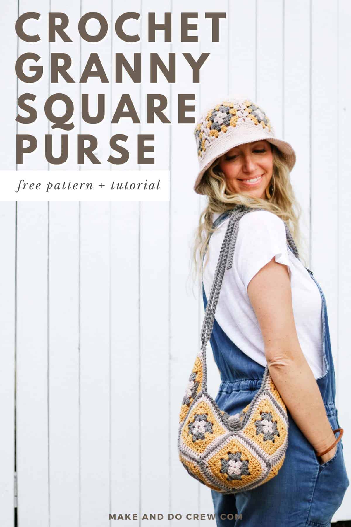 This image shows a woman with blonde hair wearing overalls, a white tee shirt, a crochet granny square hat and a crochet granny square bag. Her hands are in her pockets and she is looking over her right shoulder at the camera.