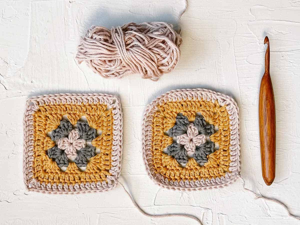 An overhead view of two crocheted granny squares, one before blocking and one after blocking.
