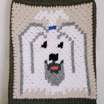 A crocheted block featuring a Havanese dog with white fur.