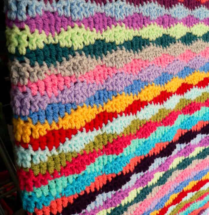 A lazy waves scrap yarn blanket pattern.