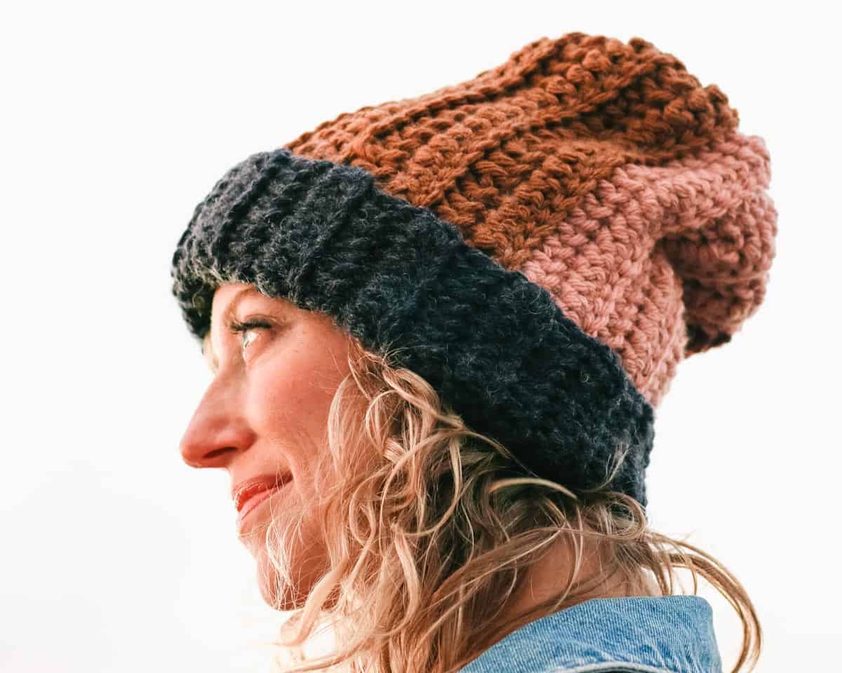 A woman wearing a colorful crochet hat.