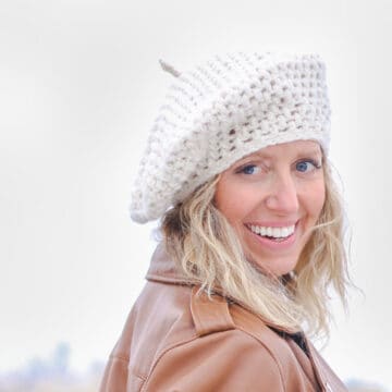 A woman wearing a white crochet beret.