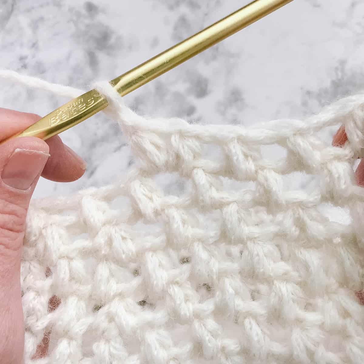 An in-progress puff stitch crochet beret pattern.