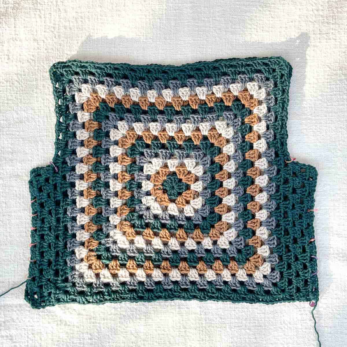 Crochet vest in progress, made from two granny squares.