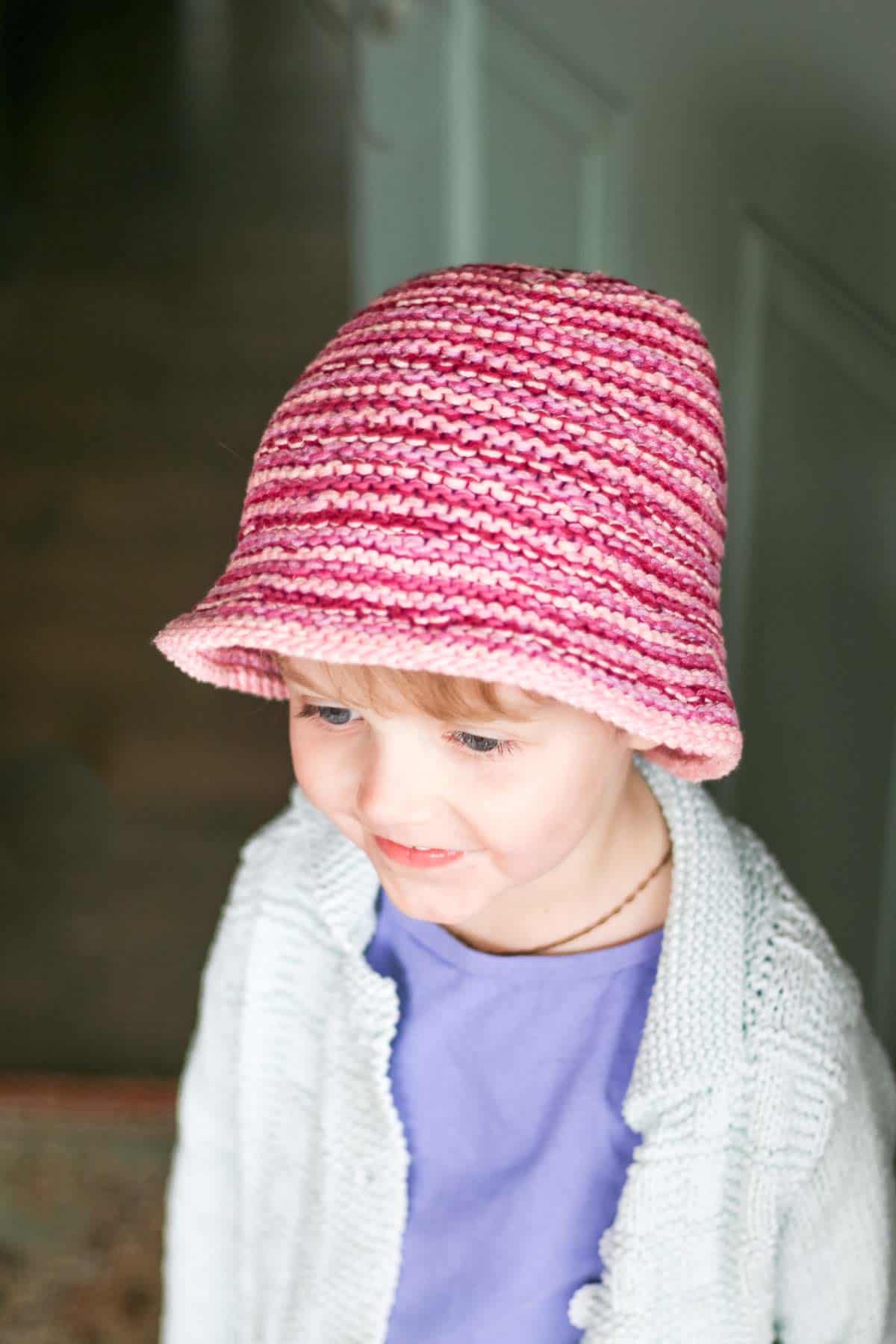 Toddler wearing a knit bucket hat.