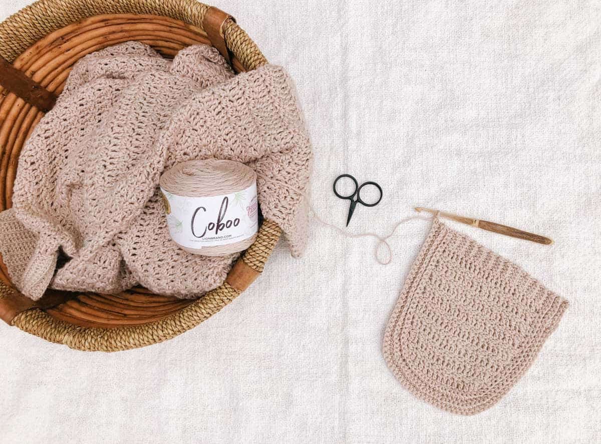 Lion Brand Coboo yarn being crocheted into a lace cardigan pocket.