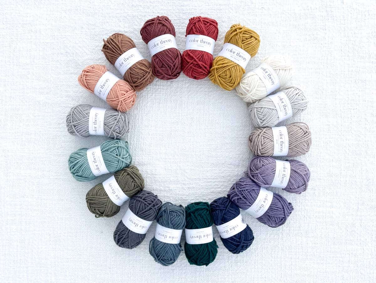 Skeins of Lion Brand Color Theory yarn in a circle.