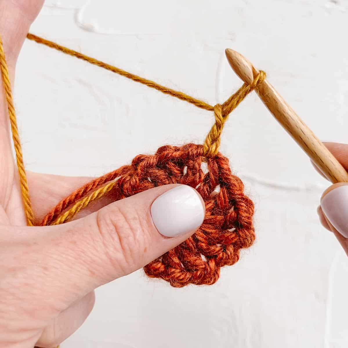 A crochet slip stitch join to start a new color in a granny square. 