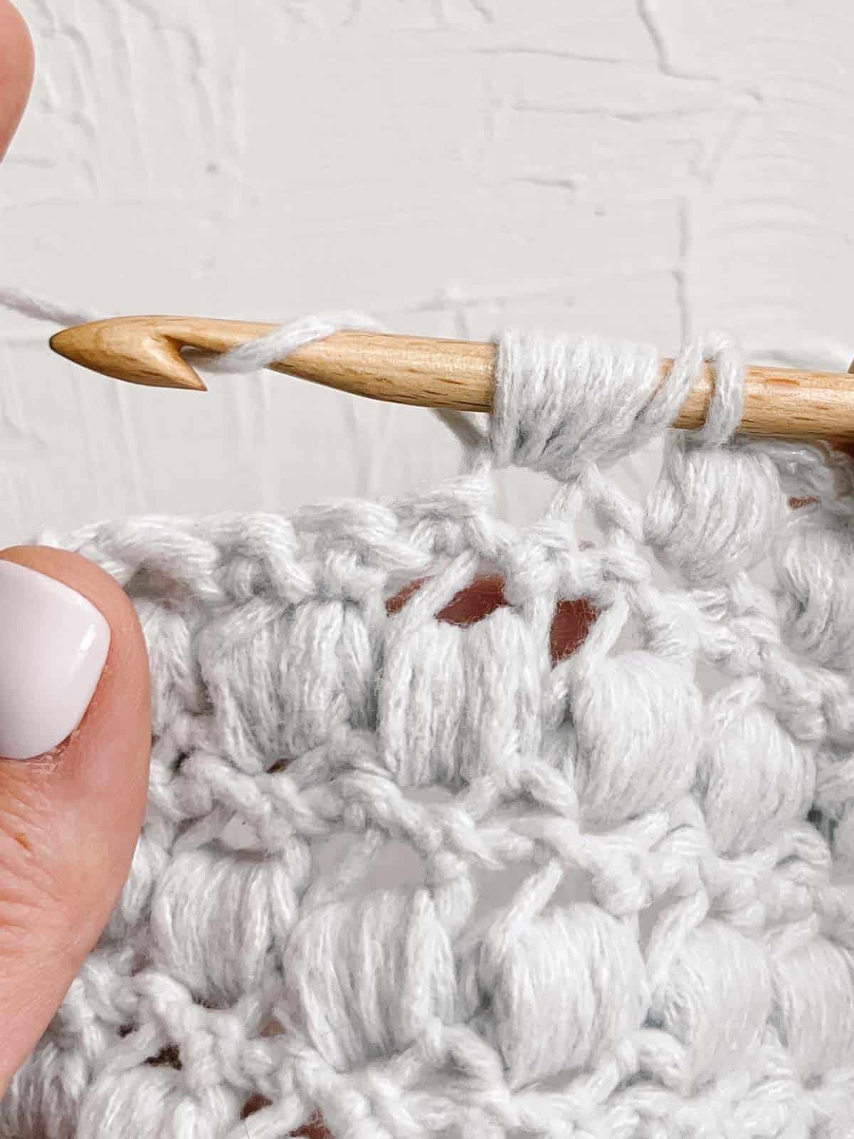 Yarn over to pull through seven loops on crochet hook.
