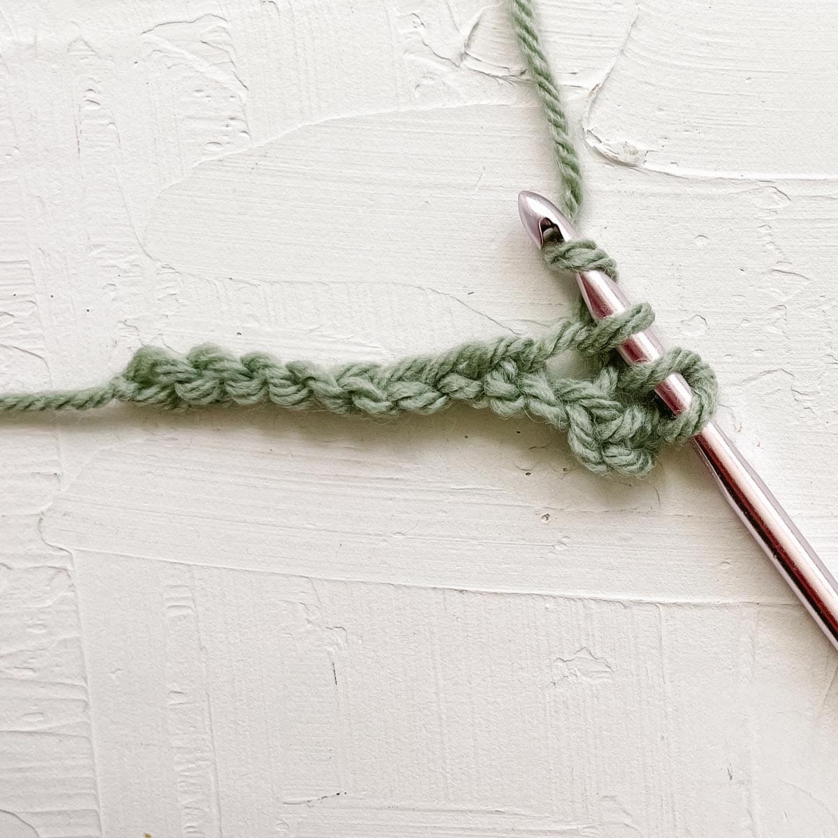 Double crochet step 2: Yarn over and pull up a loop.