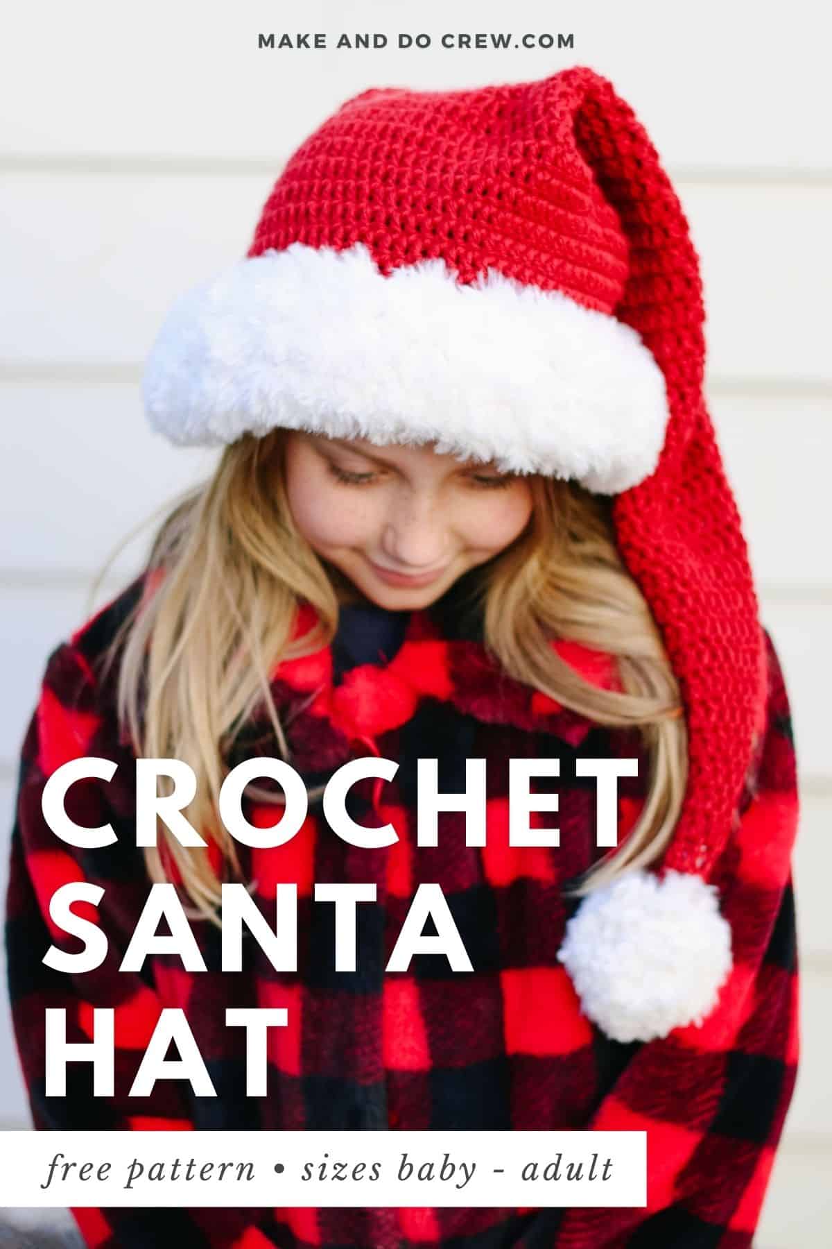 A little girl wearing a crochet santa hat pattern with pompoms at the end.