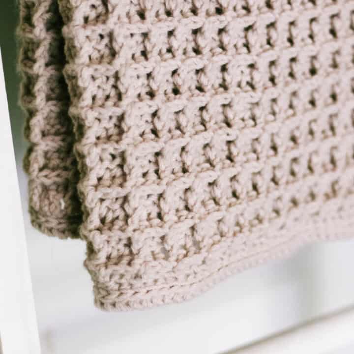 Close-up of the border around a crochet waffle stitch blanket.