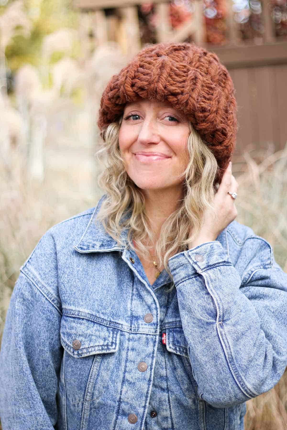 Super chunky knit hat modeled by a woman outside.