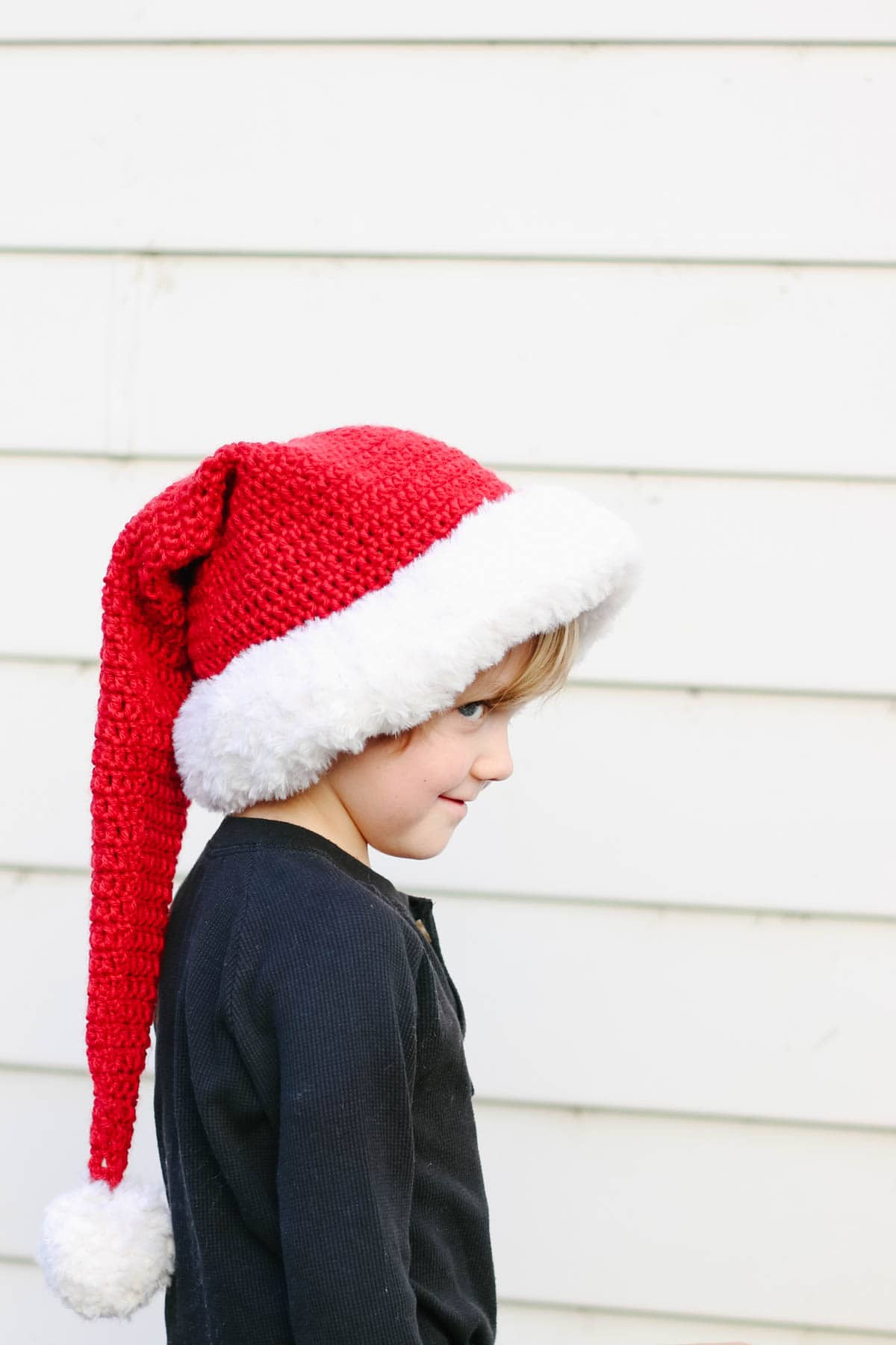 Crocheted Santa Claus hat on a young child.