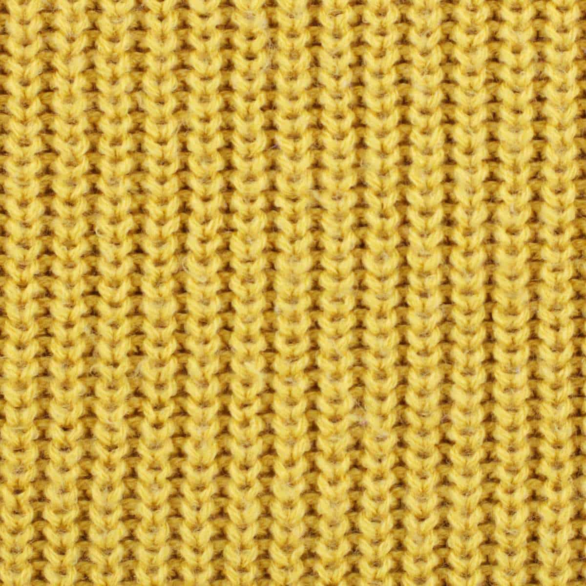 Fisherman's knit ribbing stitch in yellow yarn.