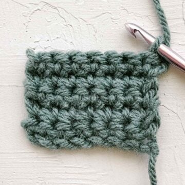 Single crochet stitches in tidy rows of green yarn.