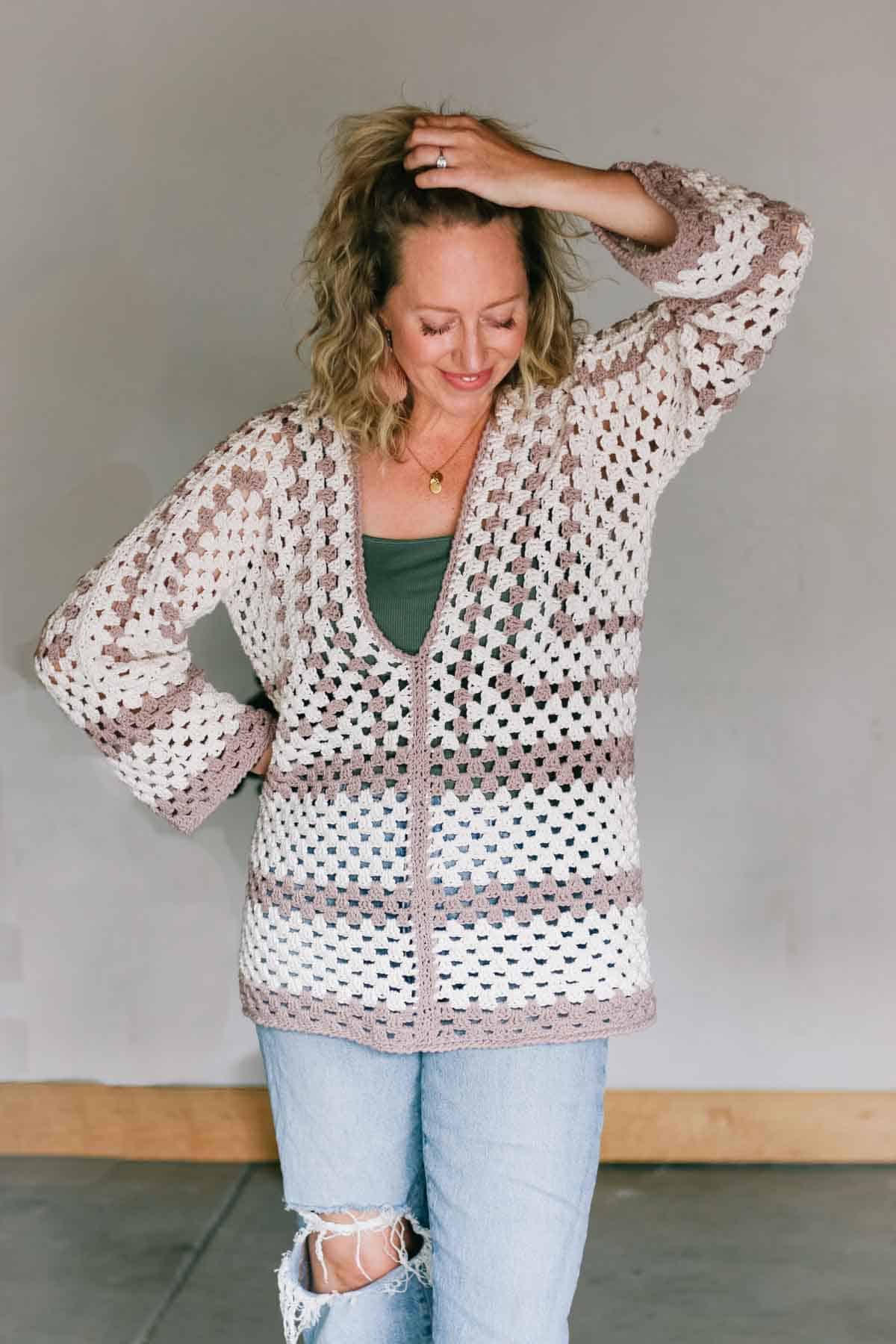 Crochet hexagon pullover sweater modeled by a blond woman wearing jeans.