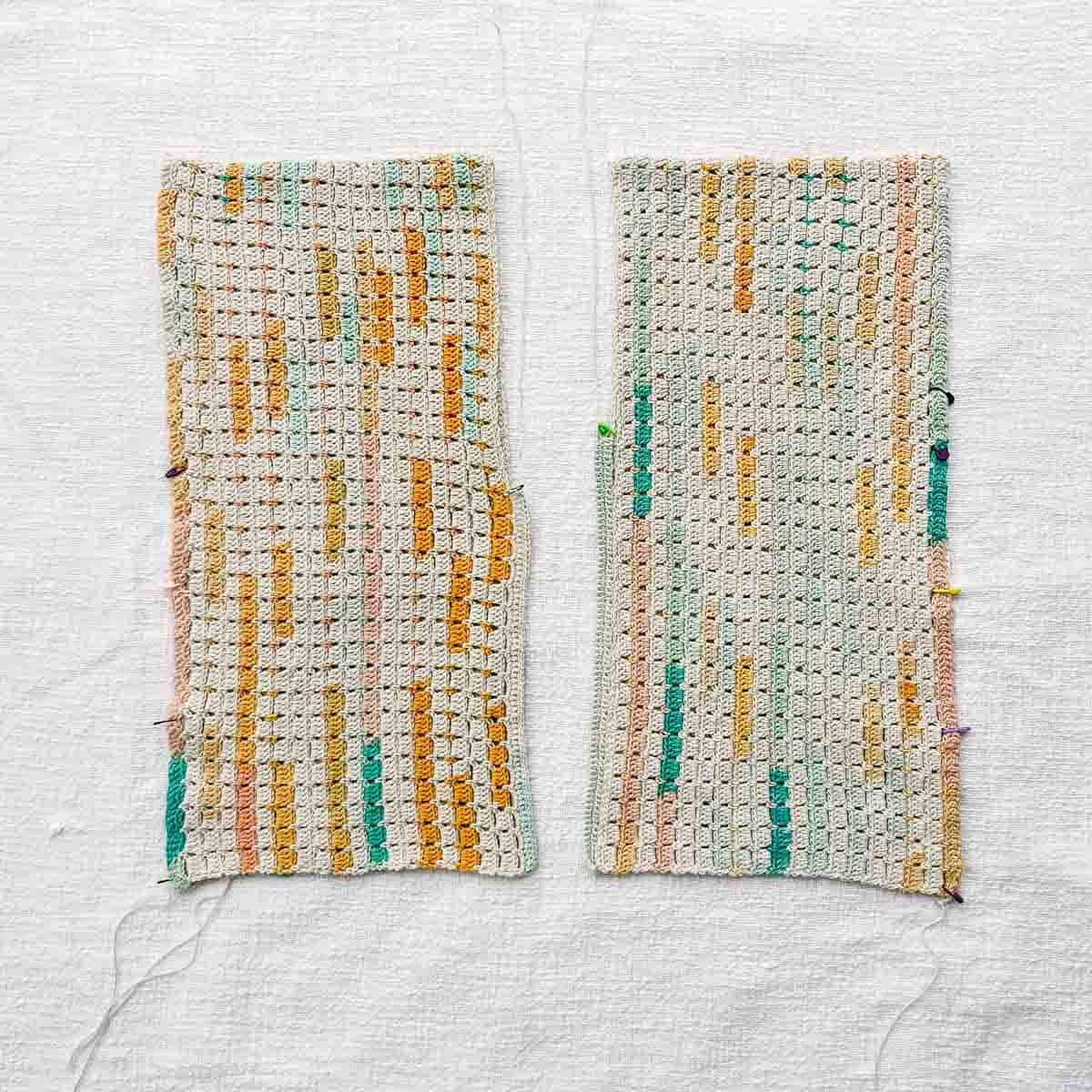 Two long crocheted rectangles laid out next to each other.