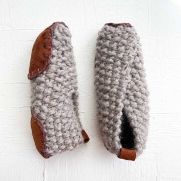 Pair of knit slippers with leather soles.