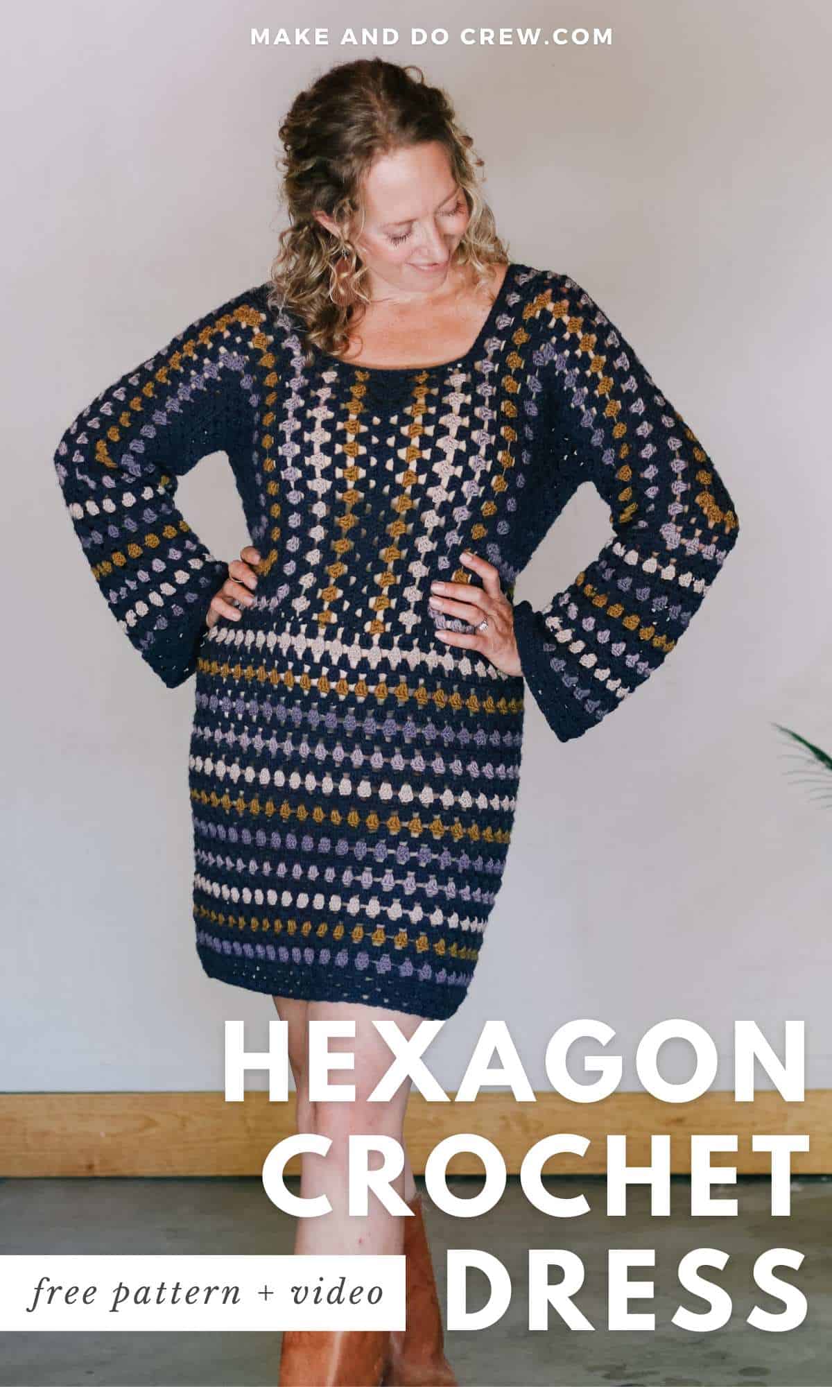 A blonde woman looking down, smiling wearing a hexagon crochet dress.