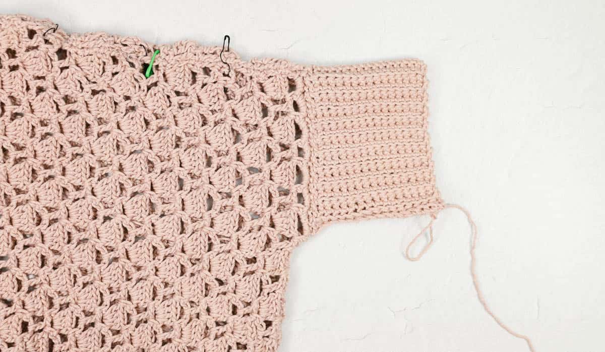 Crochet poncho with cuff sleeves.