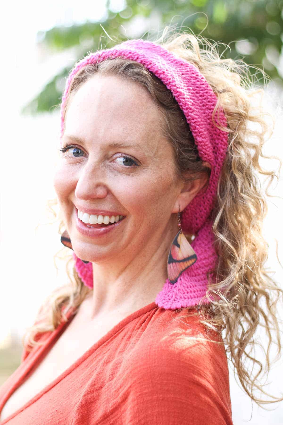 A small Tunisian crochet scarf worn as a headband.