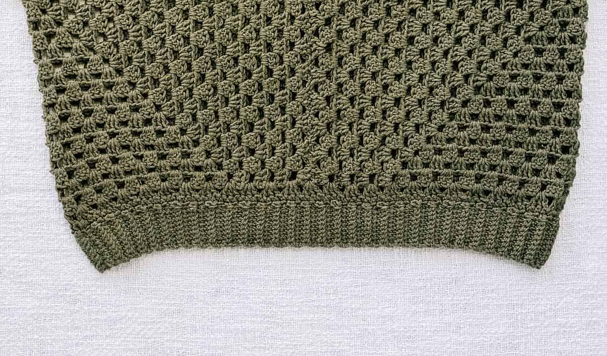 Bottom ribbed edge of a crochet sweaters made from hexagons.