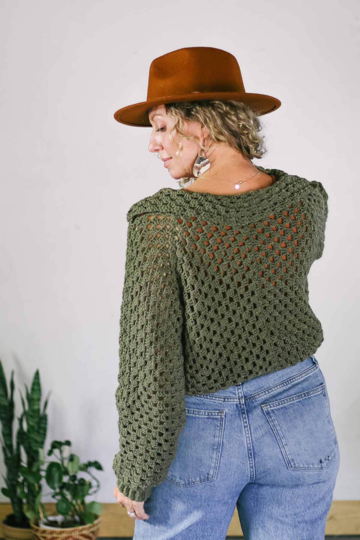 Back view of a crocheted cropped hexagon sweater.
