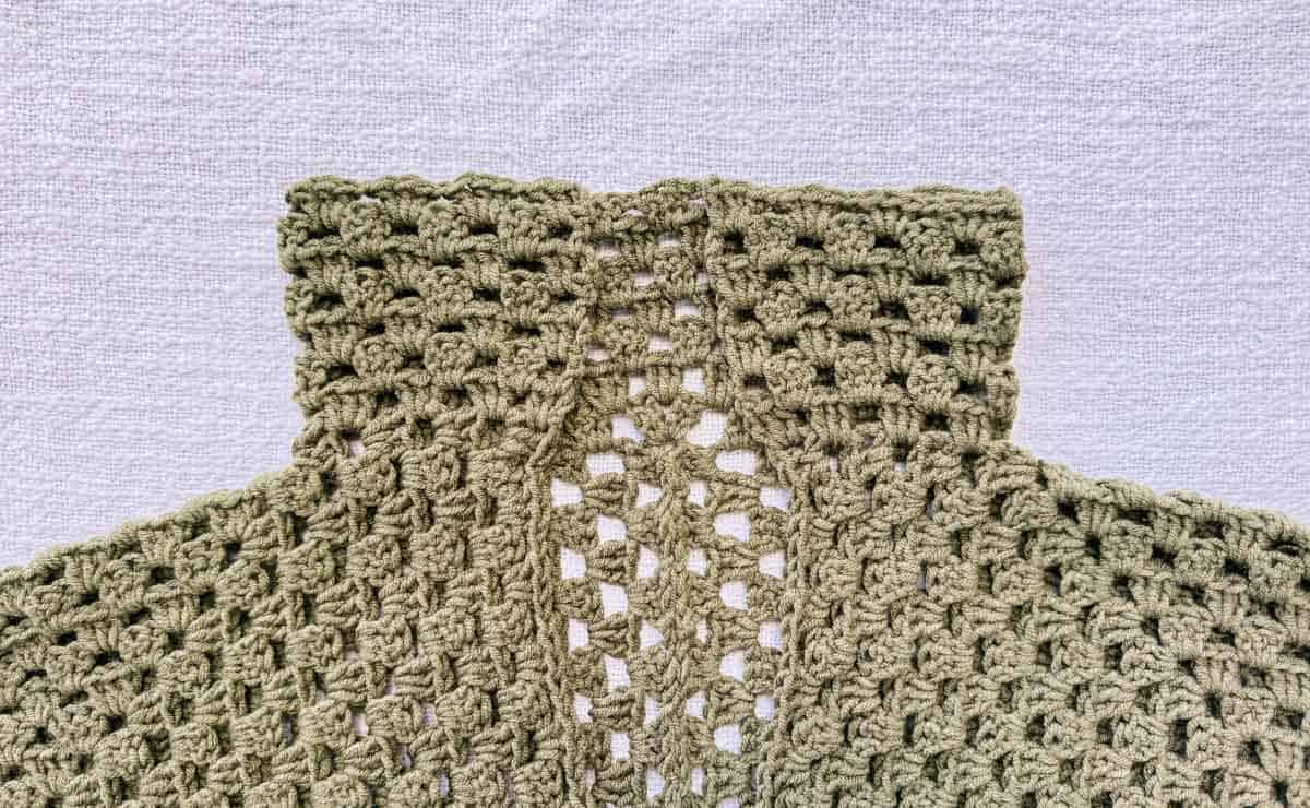 Collar of a crocheted hexagon sweater made with granny stitches.