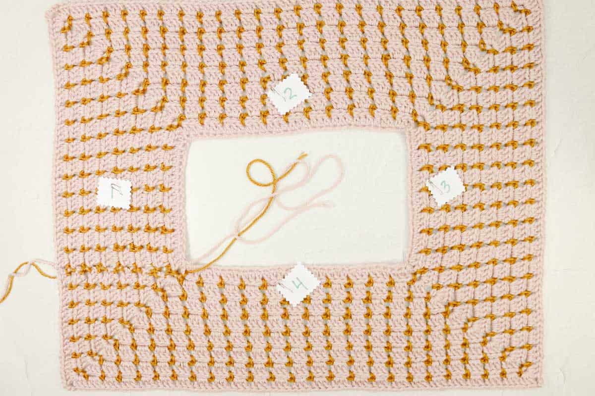 A finished yoke portion of a crochet raglan pullover sweater.