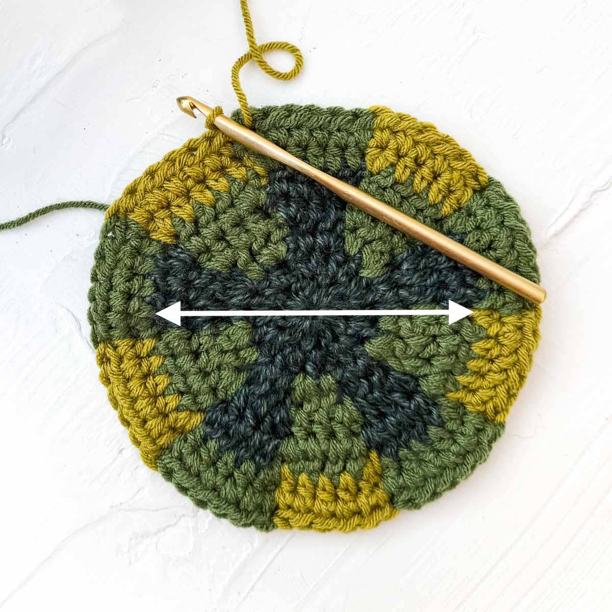 Tutorial showing how to measure across the diameter of a top down crochet hat to check gauge.