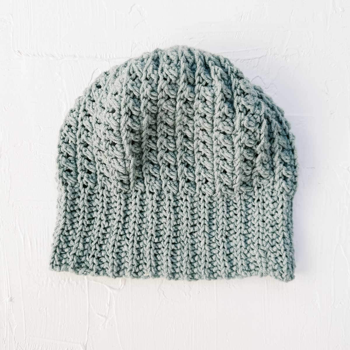 Crochet hat with bars of visual texture on a white background.