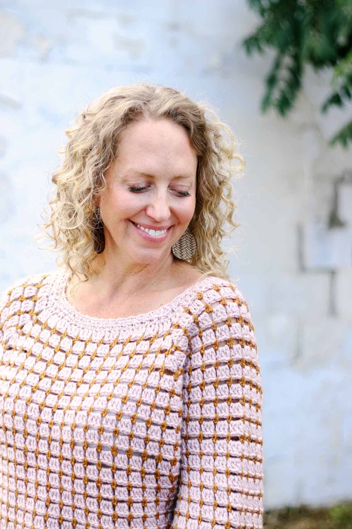 A crocheted yoke sweater made with Lion Brand Heartland yarn modeled by Jess Coppom, the pattern's designer.