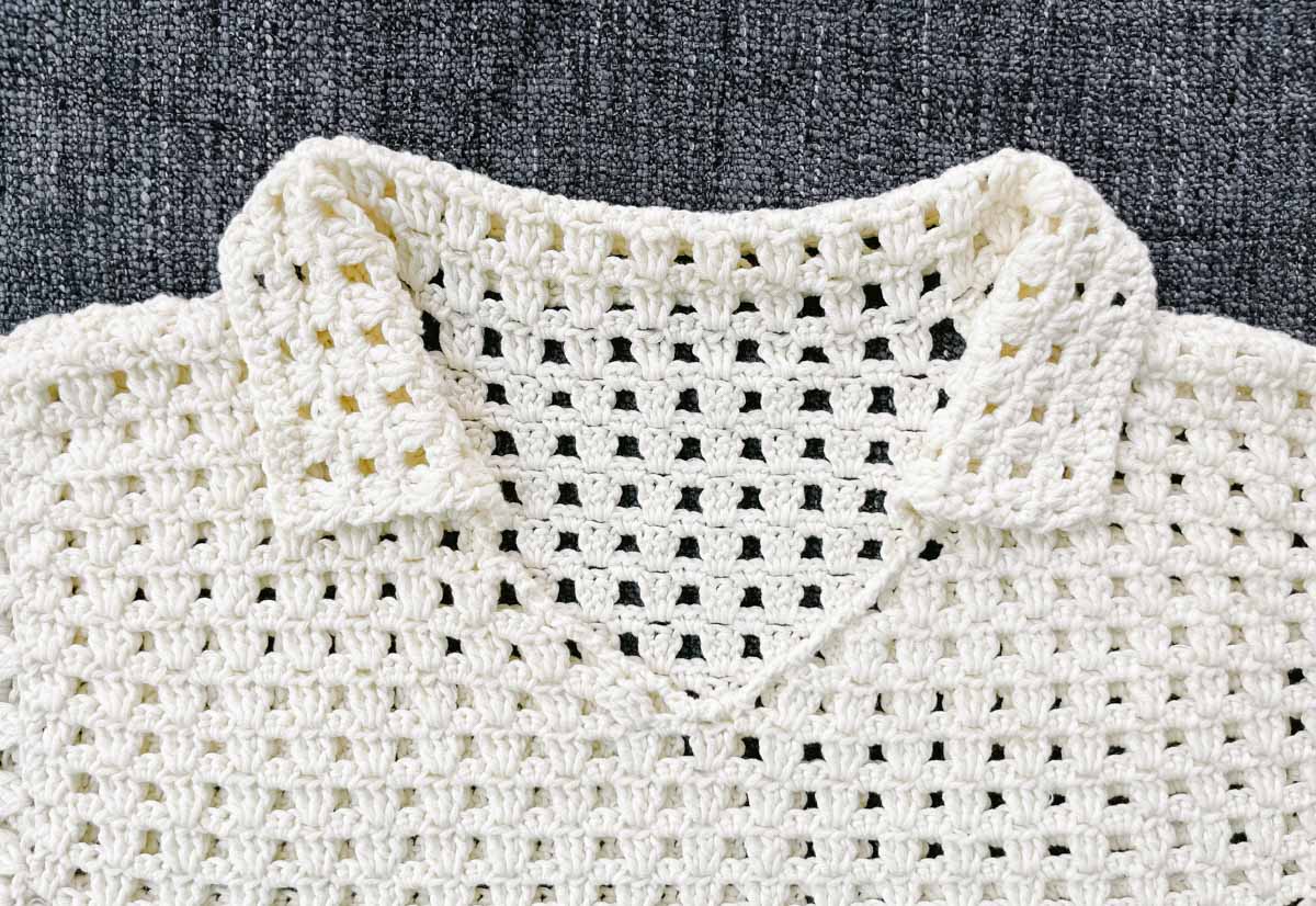 Closeup of a crocheted collar on a shirt.