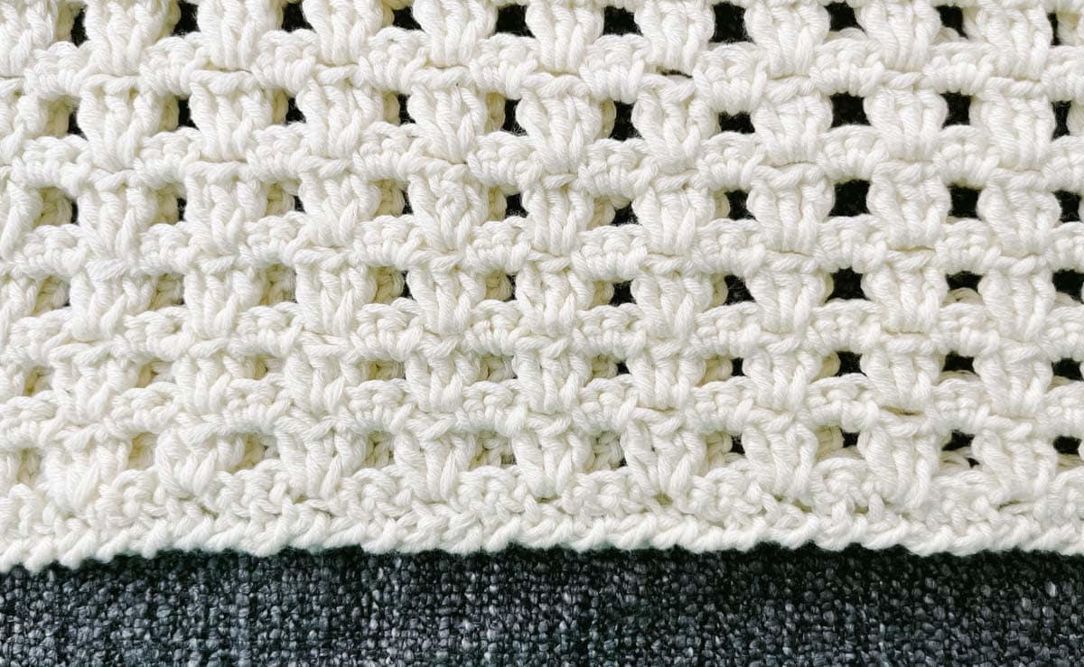 Crab stitch border on a mesh crochet tee.