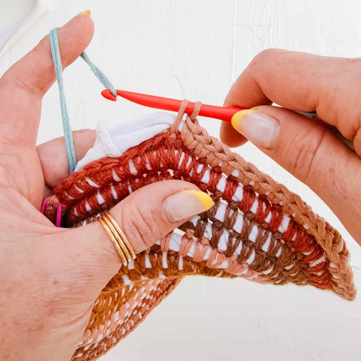 How to change colors in crochet by completing the final yarn over with the new color.