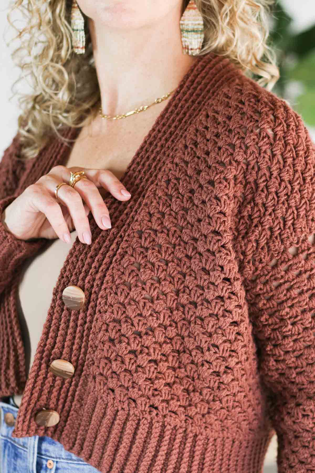 Close-up of the V-neck lapel and wooden buttons on Make & Do Crew's cropped half double crochet cardigan.
