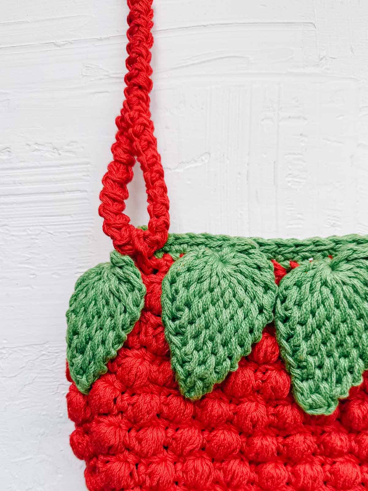 Tunisian crochet strawberry leaves and a crocheted Romanian purse strap.